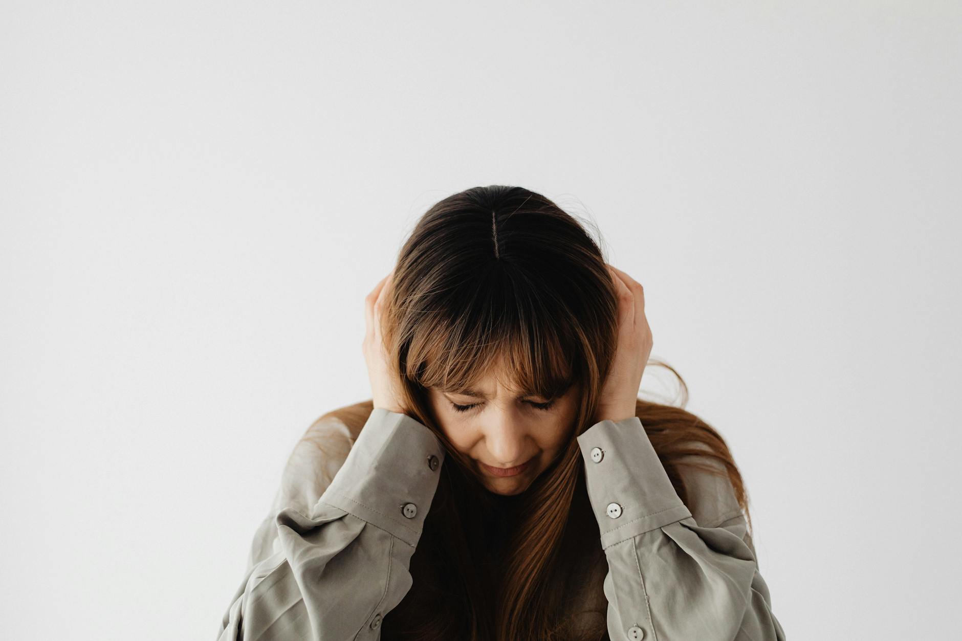 woman with hands on head